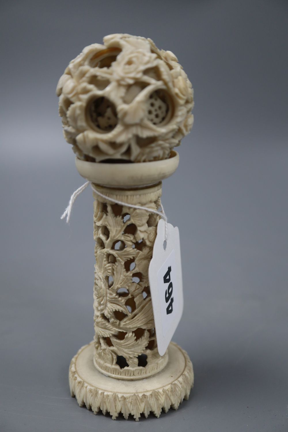 An ivory concentric puzzle ball on stand, overall height 15cm